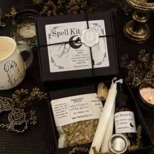 Luxury abundance spell kit gift box containing herbs, spell candles, candle dressing oil, citrine crystal and candle holder for prosperity and wealth magic.