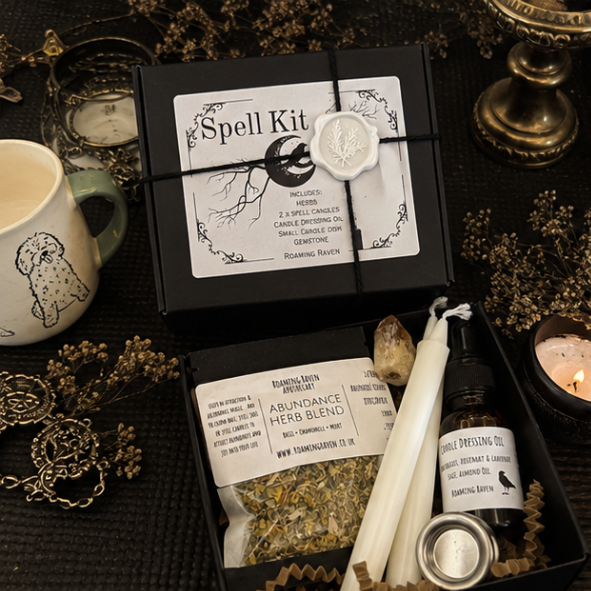 Luxury abundance spell kit gift box containing herbs, spell candles, candle dressing oil, citrine crystal and candle holder for prosperity and wealth magic.