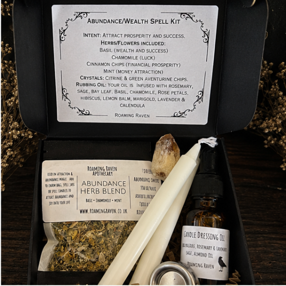 Black presentation box tied with twine and wax seal containing a handmade abundance spell kit for prosperity, success and manifestation.