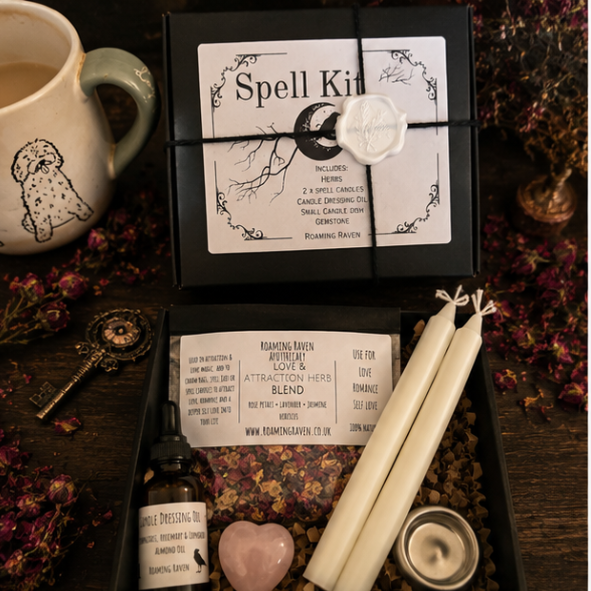 Luxury love and attraction spell kit featuring herbal blend, candle dressing oil, white spell candles, rose quartz crystal and ritual candle holder in a gift box.