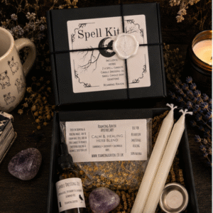 Luxury healing spell kit gift box containing calming herbs, candle dressing oil, white spell candles, amethyst crystal and candle holder for relaxation rituals.