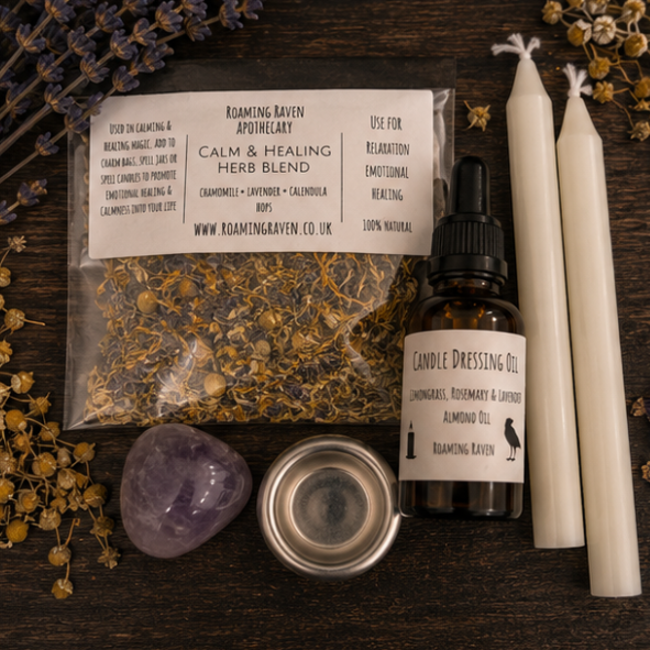 Close-up of healing spell kit contents including calming herb blend, herbal candle dressing oil, white spell candles, amethyst crystal and metal candle holder.