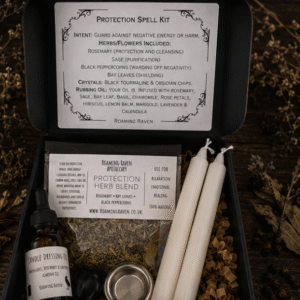 Open black presentation box displaying a protection spell kit with herbal blend, black crystal, candle dressing oil, spell candles and ritual instruction card.
