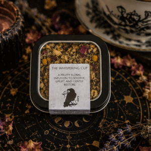 The Whispering Cup loose leaf herbal tea blend in reusable tea tin by Roaming Raven with chamomile, apple and floral botanicals