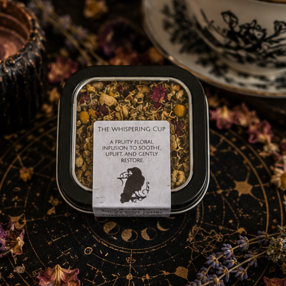 The Whispering Cup loose leaf herbal tea blend in reusable tea tin by Roaming Raven with chamomile, apple and floral botanicals