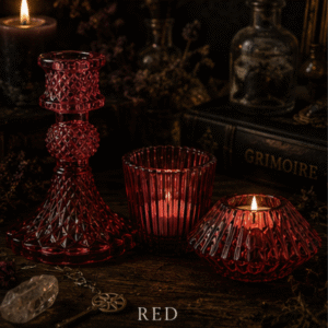 Set of three red glass candle holders including taper candle holder, ribbed tealight holder and faceted tealight holder for gothic and witchy home décor