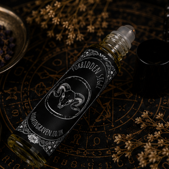 Forbidden Sigil perfume oil in a 10ml roller bottle with gothic botanical artwork by Roaming Raven.