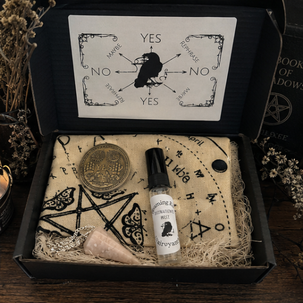 Complete witchcraft divination kit featuring a crystal pendulum, divination cloth, clairvoyant mist, yes and no decision coin and instruction cards on a mystical altar cloth.