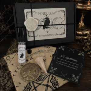 Complete witchcraft divination kit featuring a crystal pendulum, divination cloth, clairvoyant mist, yes and no decision coin and instruction cards on a mystical altar cloth.