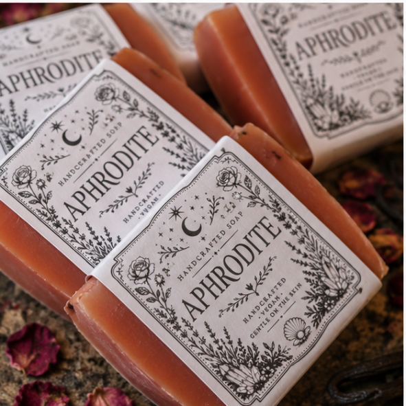 Handmade Aphrodite rose and vanilla vegan soap by Roaming Raven displayed with dried roses on a witchy altar