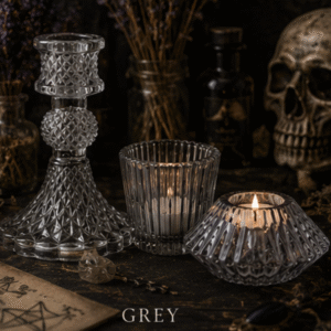 Set of three grey glass candle holders including taper candle holder, ribbed tealight holder and faceted tealight holder for gothic and witchy home décor
