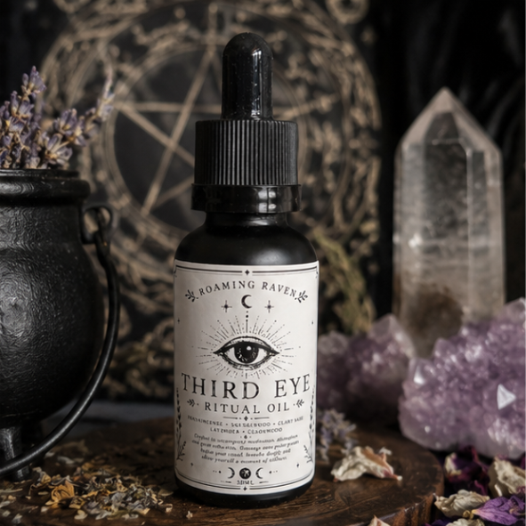 Third Eye Ritual Oil surrounded by amethyst crystals, dried herbs and a cast iron cauldron in a witchy apothecary setting.