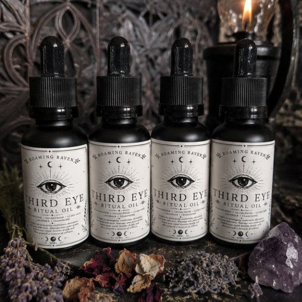 Collection of Roaming Raven Third Eye Ritual Oil bottles with dried lavender, rose petals and amethyst crystals.