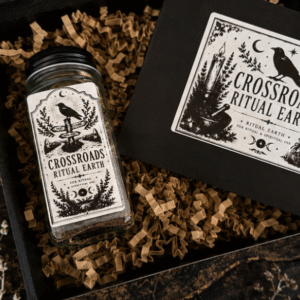 Close-up of a handcrafted Crossroads Ritual Earth jar containing layered natural earth, botanicals and ritual ingredients with a vintage witchcraft style label.